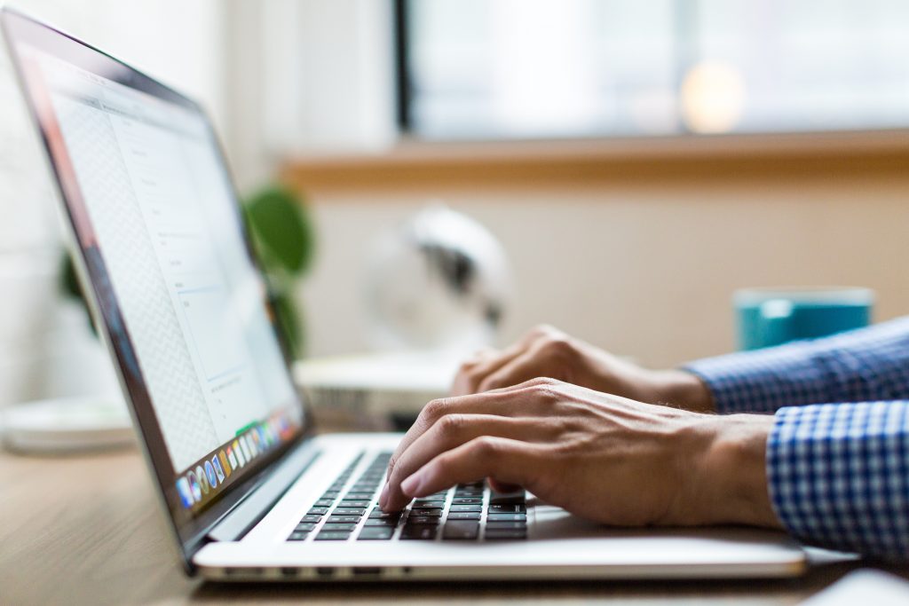 Person using MacBook laptop