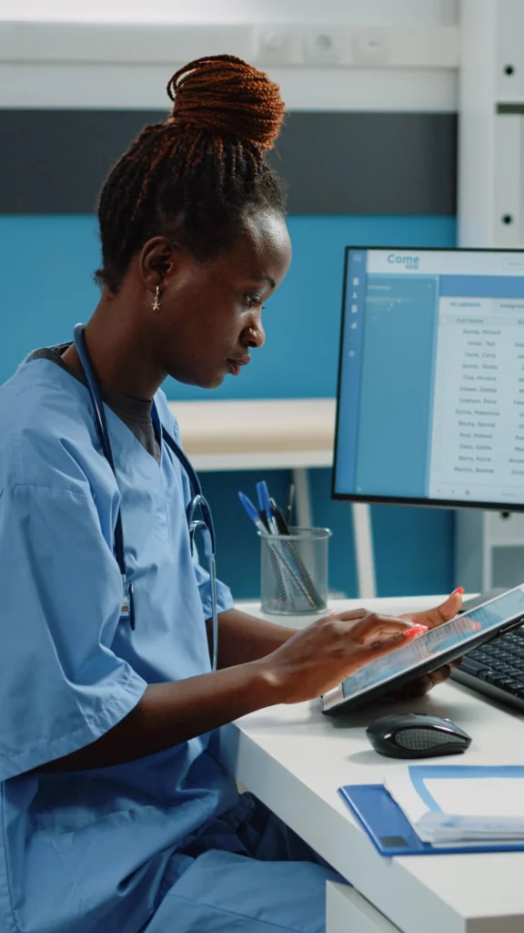Medical professional in New Jersey using a digital tablet in a healthcare setting, illustrating IT support for medical practices and HIPAA-compliant data management.