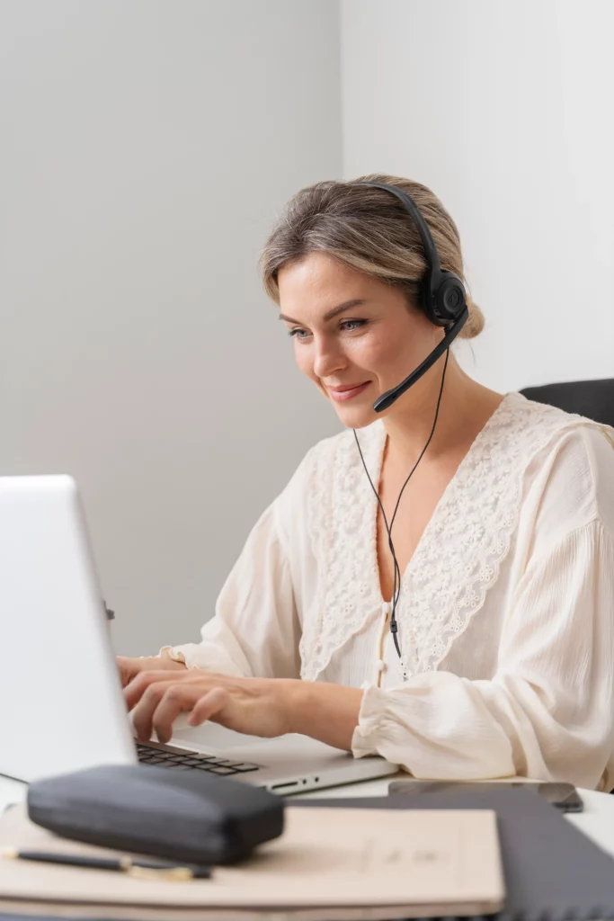 Business professional in New Jersey getting remote IT assistance on a laptop, wearing a headset and working in a clean, modern office setting.