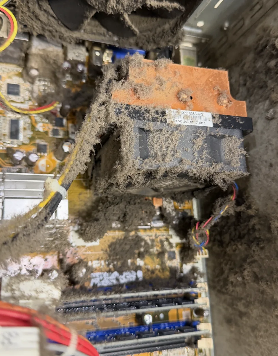 Desktop CPU heatsink and motherboard packed with thick dust causing overheating